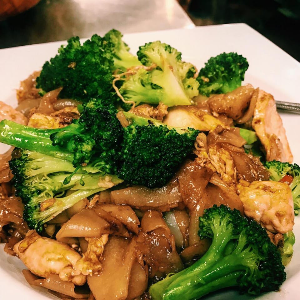 STIX Eatery's Asian dish with wide noodles, chicken, and broccoli florets in a savory sauce.
